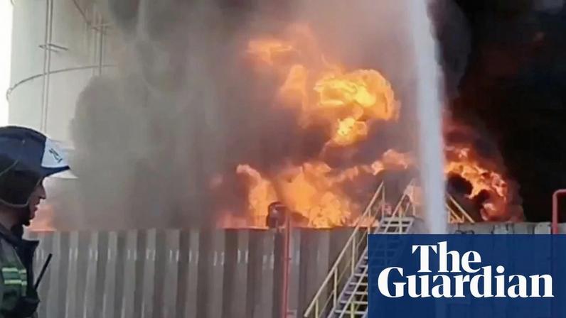 Russian emergency personnel work on an oil storage fire after an alleged drone attack in the southern region of Rostov in 2024.