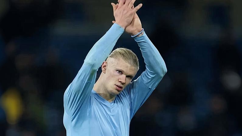 Erling Haaland applauds Man City fans after a match