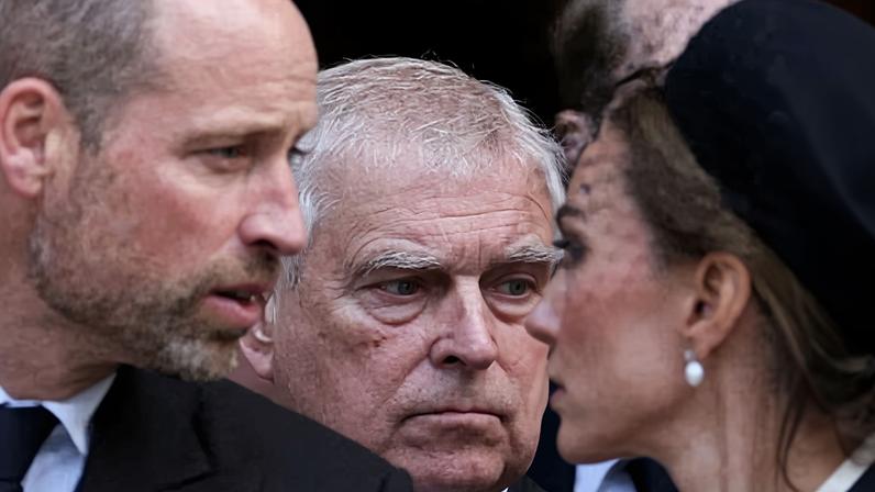 William and Kate in foreground, out of focus, with Andrew in focus inbetween them behind
