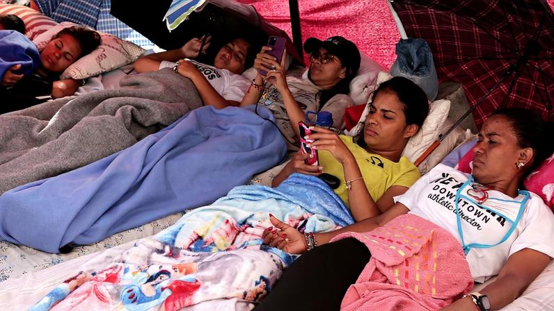 Relatives of detainees rest as they enter their third day of a hunger strike after the National Assembly of Venezuela postponed debate on an amnesty bill, outside the National Police Zone 7 detention centre in Caracas, Venezuela, February 16, 2026. REUTERS/Gaby Oraa