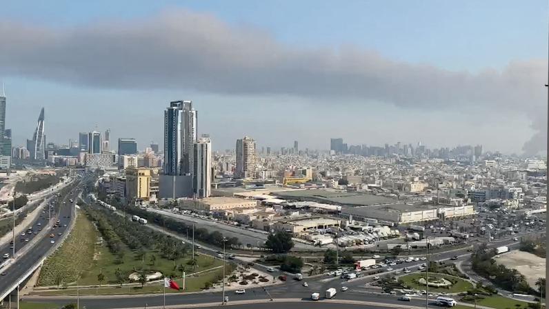 Smoke rises after the state news agency reported missile attack on the service center of the U.S. Fifth Fleet, following strikes by the United States and Israel against Iran, in Manama, Bahrain February 28, 2026, in this still image obtained from a video. Video obtained by Reuters/via REUTERS THIS IMAGE HAS BEEN SUPPLIED BY A THIRD PARTY. TPX IMAGES OF THE DAY VERIFICATION: -Buildings, road layout, and harbor matched satellite imagery -Date verified by original file metadata -Bahrain said that the service center of the U.S. Fifth Fleet had been subjected to a missile attack -Smoke is coming from the direction of the U.S. Naval Base in Manama, Bahrain