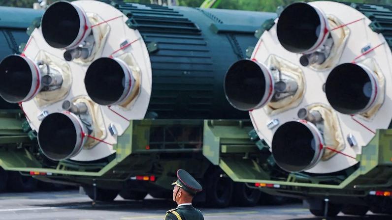A soldier of the PLA sands in front a a DF-5C nuclear missile during a military parade in Beijing