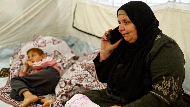 Huda Abu Abed, 56, at a tent shelter after returning to Gaza through the Rafah crossing, in Khan Younis