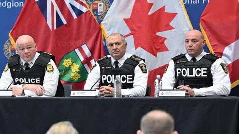 The Toronto police service chief, Myron Demkiw, left, is joined by York regional police chief, Jim MacSween, center, and his deputy, Ryan Hogan, at a news conference.