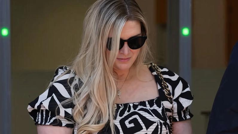 Lauren Ashley-Mastrosa leaves Blacktown Local Court in Sydney, Thursday, December 4, 2025. A Christian charity marketing executive who moonlights as a taboo erotic fiction author has been charged over allegations her latest book contains child abuse material. (AAP Image/Dan Himbrechts) NO ARCHIVING