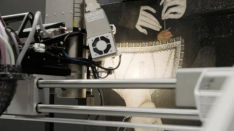 Close up of the painting being examined using some sort of laser machine