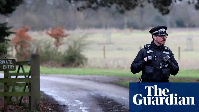 A police officer stands at the entrance to the Wood Farm on the Sandringham estate.