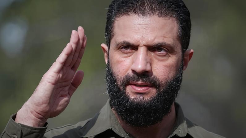 Syria's president, Ahmed al-Sharaa, salutes during celebrations to mark the first anniversary of the ousting of Bashar al-Assad in December.