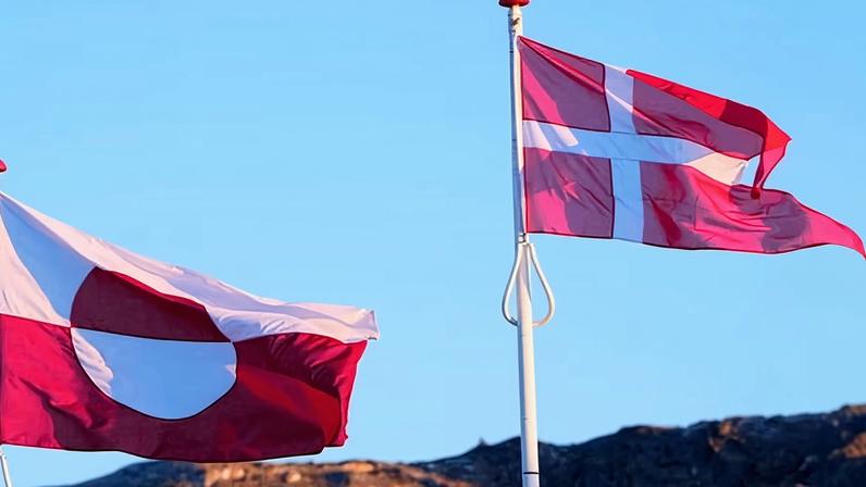 Flags of Greenland and Denmark side by side.
