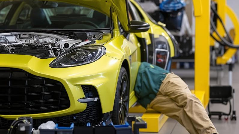 An employee works on an Aston Martin SUV in St Athan, south Wales. Across British manufacturing, factory output fell over the three months to February.