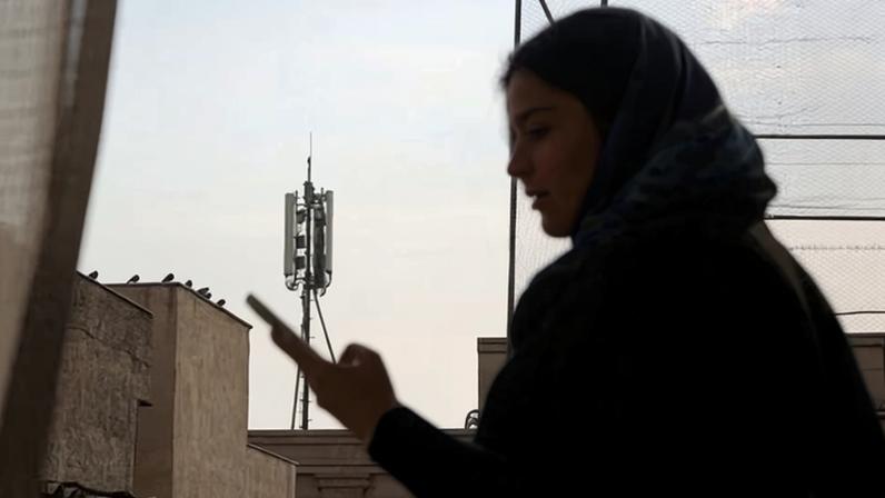 A teacher in Tehran on her mobile phone. The concept of a splinternet is becoming reality for many millions of people.