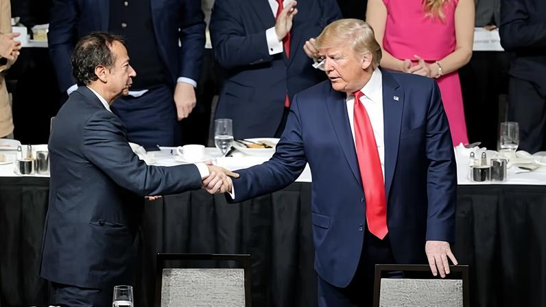 Donald Trump, right, shakes hands with John Paulson during a meeting of the Economic Club of New York on 12 November.