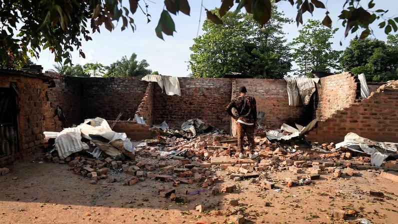 A man stands in front of a damaged and burnt house following a deadly gunmen attack in Yelwata, Benue State, Nigeria, June 16, 2025. REUTERS/Marvellous Durowaiye/File Photo