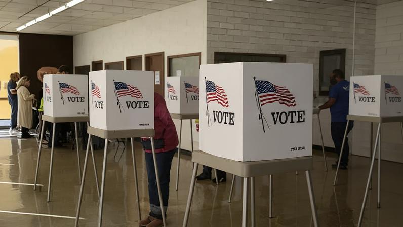 People cast ballots at an early voting polling location for the 2020 presidential elections in Iowa.