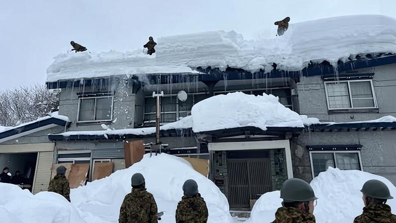 Japan defence personnel carry out snow removal work in a town within Aomori Prefecture.