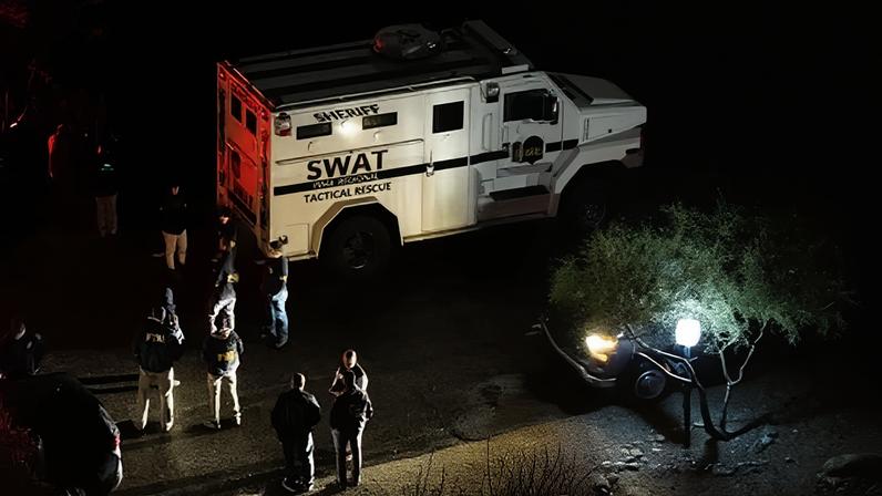 FBI and Pima county sheriff units perform operations approximately two miles from Nancy Guthrie's residence on 13 February 2026 in Tucson, Arizona.