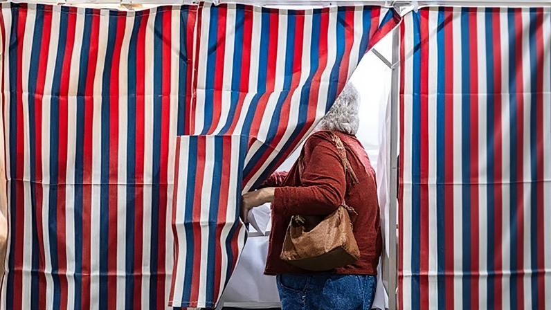 A person at a polling booth in New Hampshire at the presidential election in 2024.