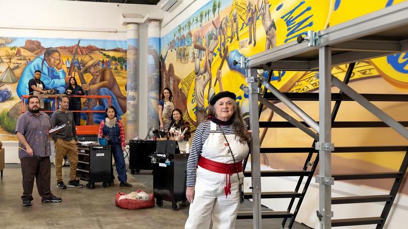 Judith F. Baca with the Social and Public Art Resource Center team working on the newest section of The Great Wall of Los Angeles