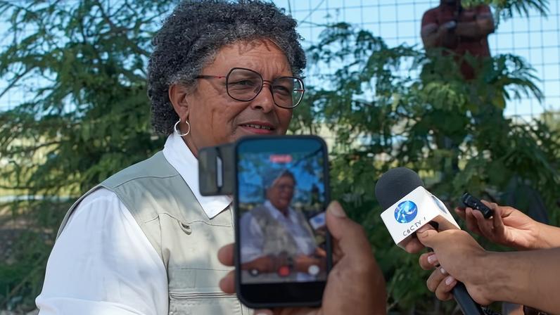 Mia Mottley pauses to answer press questions yesterday after casting her ballot in Bridgetown.