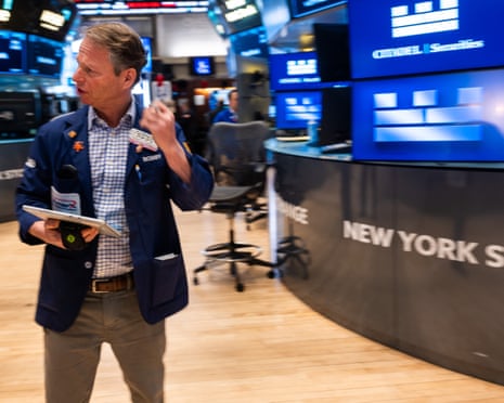 Traders on the floor of the New York Stock Exchange as markets fell on Friday morning trading after a steep drop on Thursday, as investors continue to worry about the impact of AI on business and the wider economy.