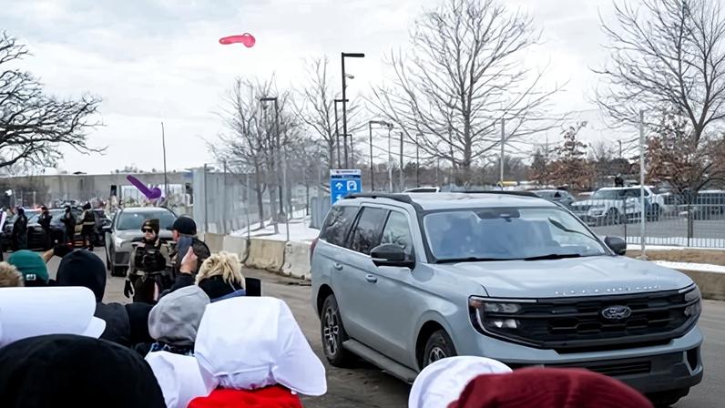 People throw sex toys at a vehicle driven by federal agents outside the Bishop Henry Whipple federal building on 7 February 2026 just south of Minneapolis, Minnesota.