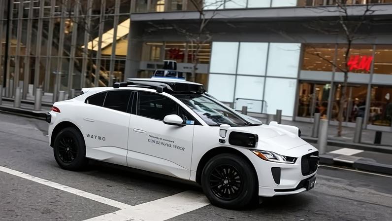 A Waymo driverless taxi drives in lower Manhattan in New York City on 26 November 2025.