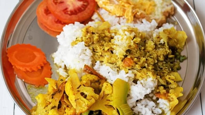 A serving of dal bhat, a traditional Nepali dish made with rice and lentils.