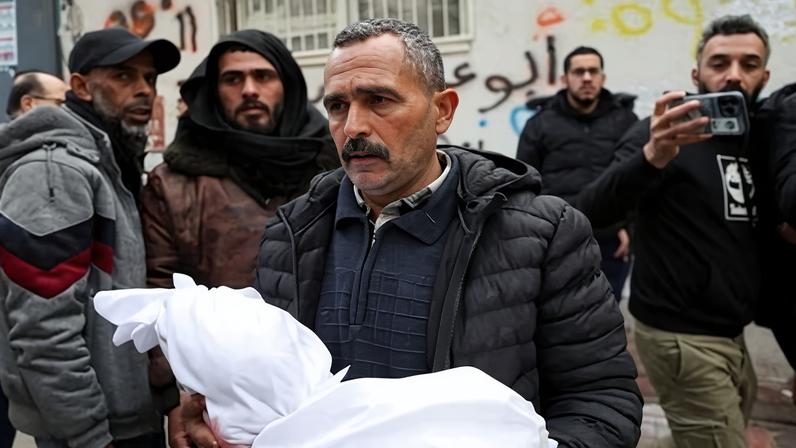 A man carries the body of a Palestinian who was reportedly killed by an Israeli strike on Wednesday in Gaza City.