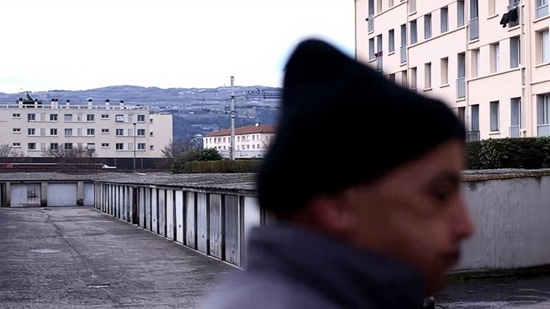 A man walks past a garage where two women were found on Friday in Bourg-lès-Valence, in the Drome department, south-eastern France.