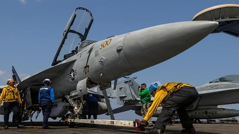 Sailors preparing a Boeing EA-18G Growler on the flightdeck of the USS Abraham Lincoln