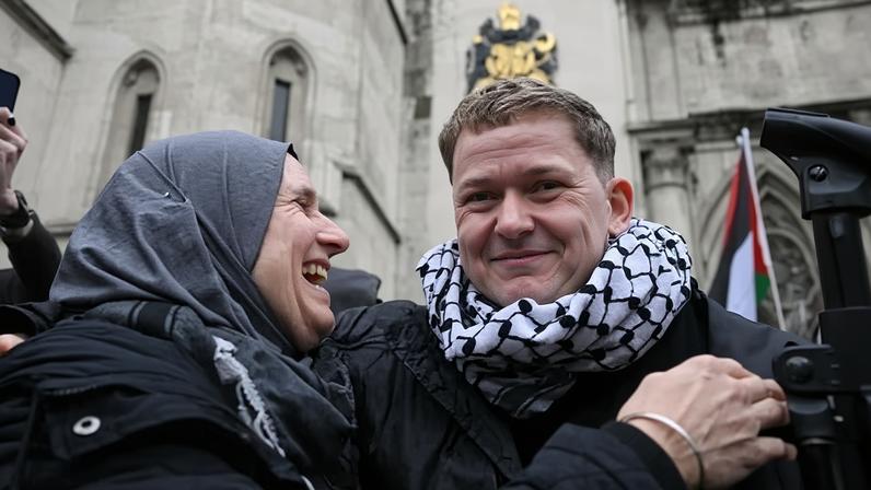 People celebrate outside the Royal Courts of Justice on Friday after high court judges ruled that the ban was unlawful.