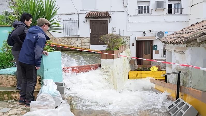 Residents look at a flooded street in the village of Ubrique, in Cadiz, south-west Spain, after parts of the Iberian peninsula were hit by Storms Marta, Leonardo and Kristin.
