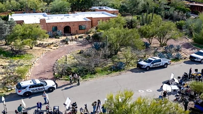 In an aerial view, law enforcement and news broadcasters are stationed outside Nancy Guthrie's residence on 10 February 2026 in Tucson, Arizona.
