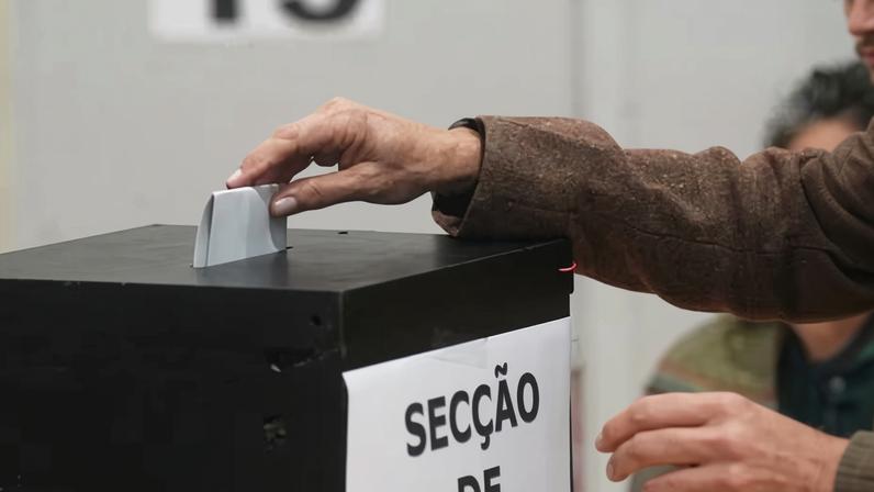 A voter casts her ballot on Friday at a polling station during the presidential election in Lisbon.