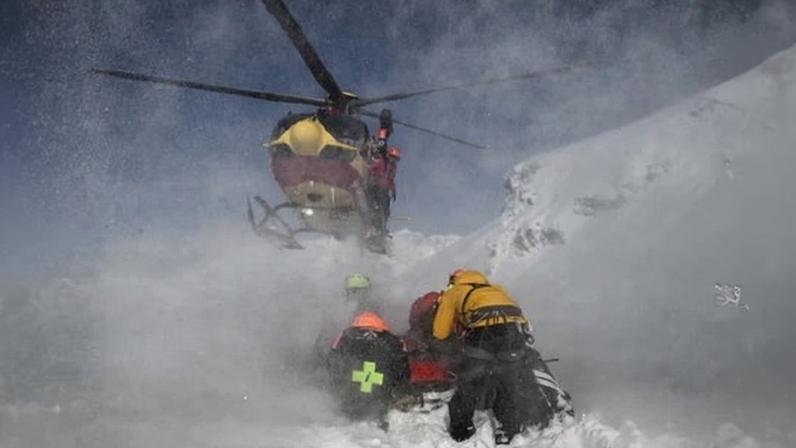 Rescuers in protective clothing amid snow in the French Alps
