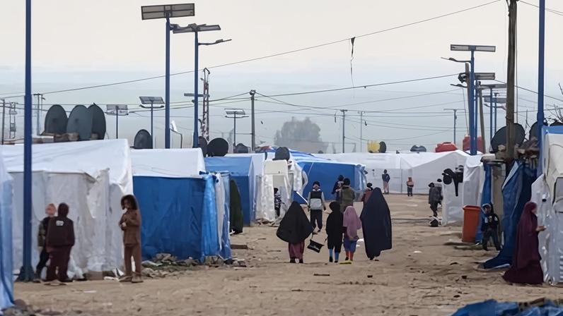 Women and children walk among tents at al-Roj camp in Syria. A group of 34 Australian women and children are at the camp.