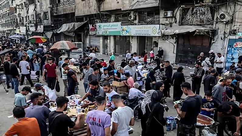 Palestinians gather around street vendors in Gaza City in October last year. At the peak of the conflict, a single cigarette could sell for $15 (£11) and a carton of 50 packets nearly $15,000 (£11,060). Photograph: Anadolu/Getty Images