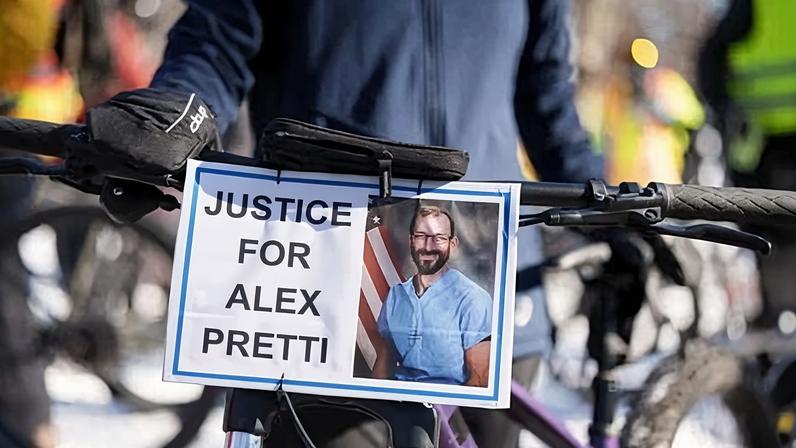 A sign demanding justice for Alex Pretti hangs from handlebars before a memorial unity bike ride for Pretti in Minneapolis, Minnesota, on Saturday.