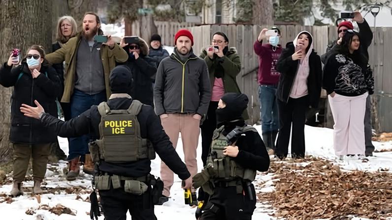 Observers film ICE agents in Minneapolis earlier this month.