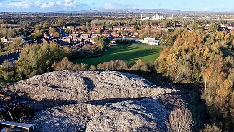 Last summer the illegal dump in Wigan caught fire for 10 days, forcing the nearby school to close.
