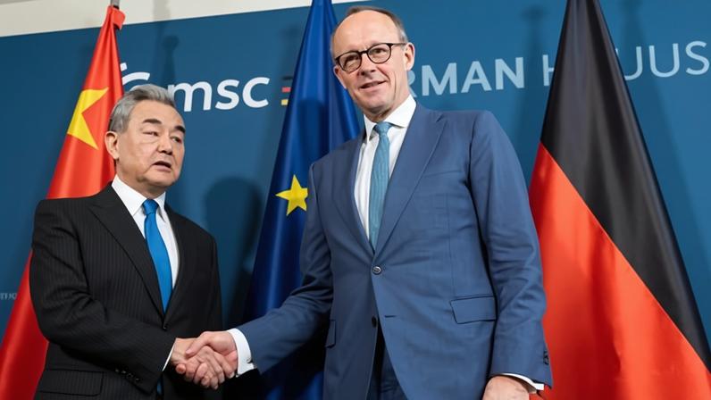 Friedrich Merz with the Chinese foreign minister, Wang Yi, at the Munich Security Conference earlier this month.