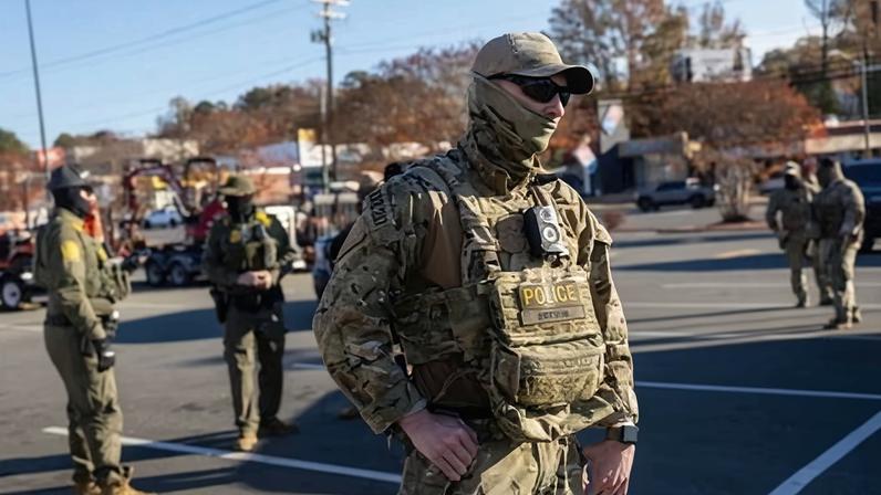 Border Patrol agents stand outside a Home Depot store on 19 November 2025 in Charlotte, North Carolina.