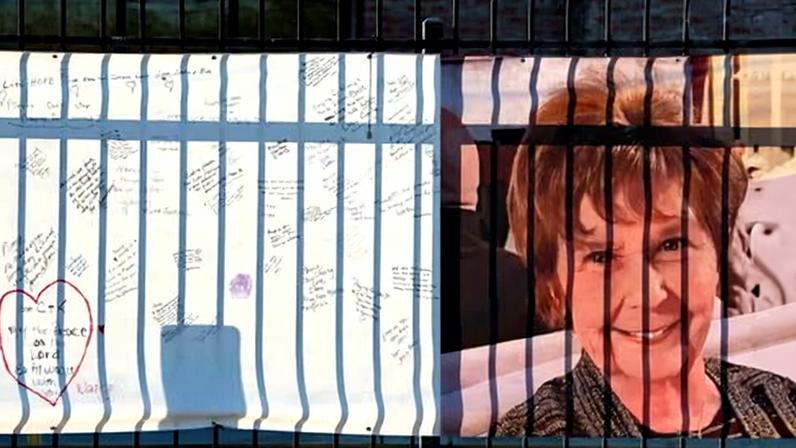 A banner with well-wishes from supporters and a photo of Nancy Guthrie, mother of Today show host Savannah Guthrie, outside of KVOA newsroom in Tucson, Arizona.