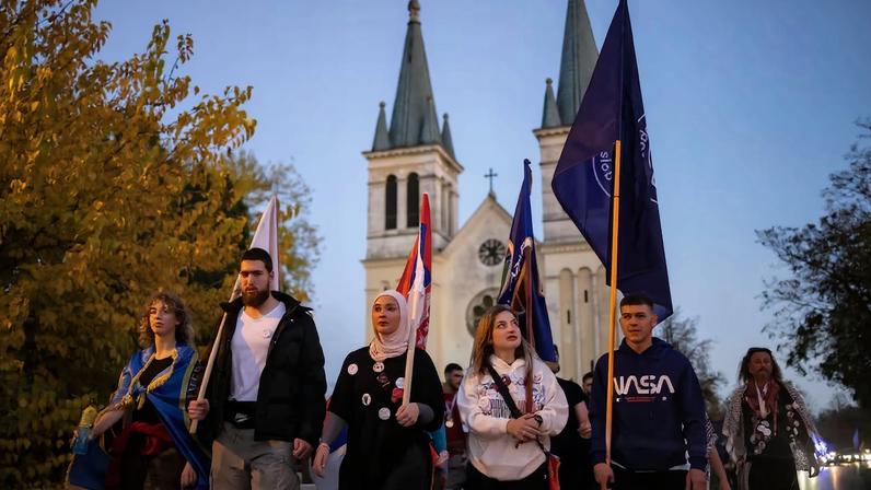 Students from Novi Pazar walk past a church before entering Novi Sad, after completing a walk of more than 400 km from Novi Pazar, in Novi Sad, Serbia, October 31, 2025. A year-long blockade of Novi Pazar University by the students, which had stopped lectures from taking place, ended little over a week ago, after the replacement of the university's rector and the reversal of a ban on 200 students, who had been expelled for their anti-government activism. Their protest outlasted those at most other universities in Serbia, and saw students occupy the buildings even after authorities had cut the heating. REUTERS/Marko Djurica