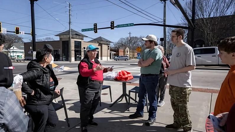 Gareth Fenley speaks to a group of canvassers before walking around downtown Social Circle to inform residents about the ICE holding facility in Georgia on 12 February.