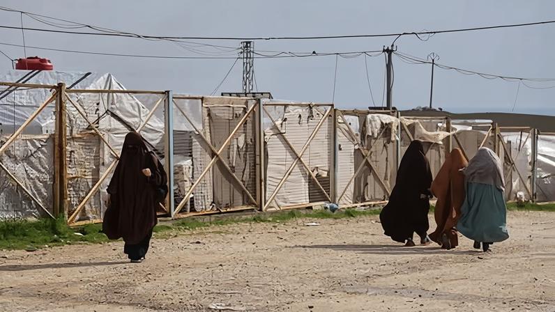 Unidentified women move through the Roj camp in eastern Syria where family members of suspected Islamic State militants are held.