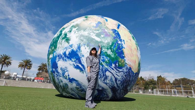 For her durational performance *Untitled Orbit (MANUAL MODE)* (2026), the artist Amanda Ross-Ho will push a 16ft inflatable Earth around the Santa Monica airport football pitch throughout the fair