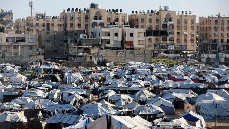 Palestinians displaced during the two-year Israeli offensive shelter at a tent camp in Khan Younis in the southern Gaza Strip, February 10, 2026.