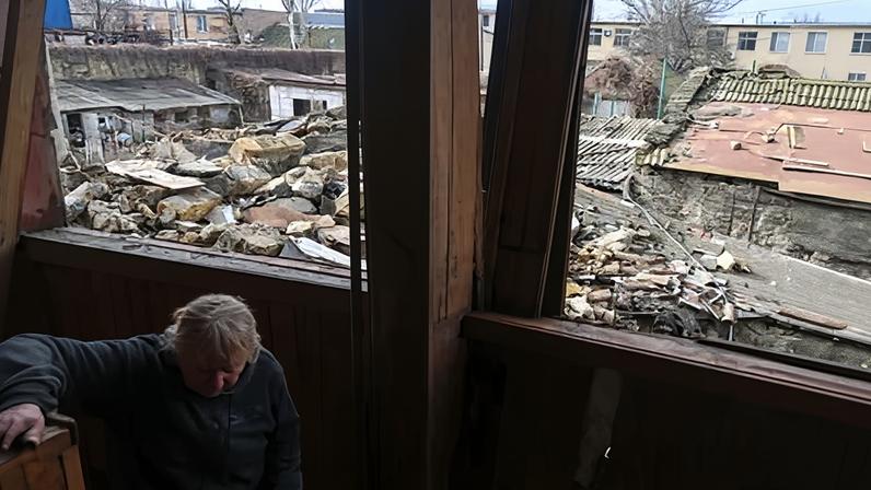 A local woman at the site of a Russian strike on Odesa, where drone debris also hit infrastructure.