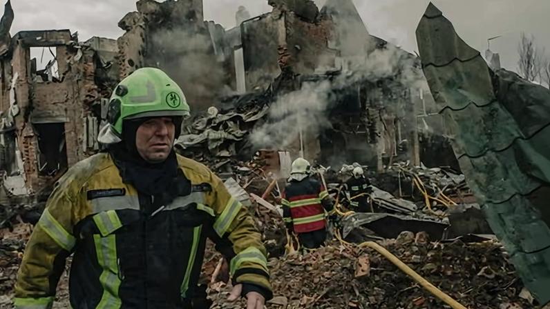 Firefighters work at the site of a Russian missile strike on a residential area in Kyiv.